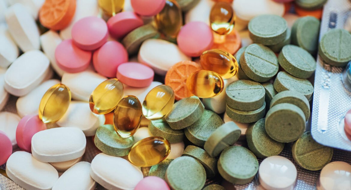 Medical colorful pills, capsules or supplements for the treatment and health care on a light background.