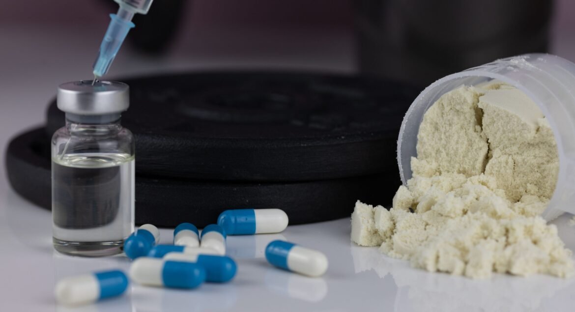 A powder in scoop with pills and syringe with needle