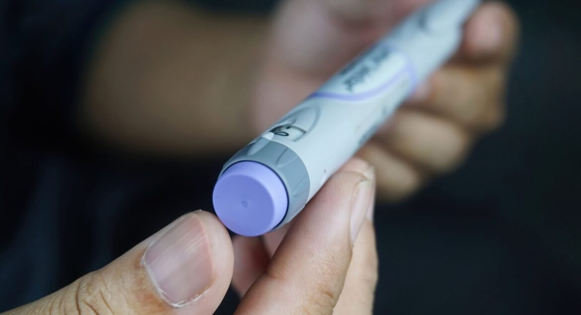 A closeup of a male hands holding insulin pen - Medical equipment concept