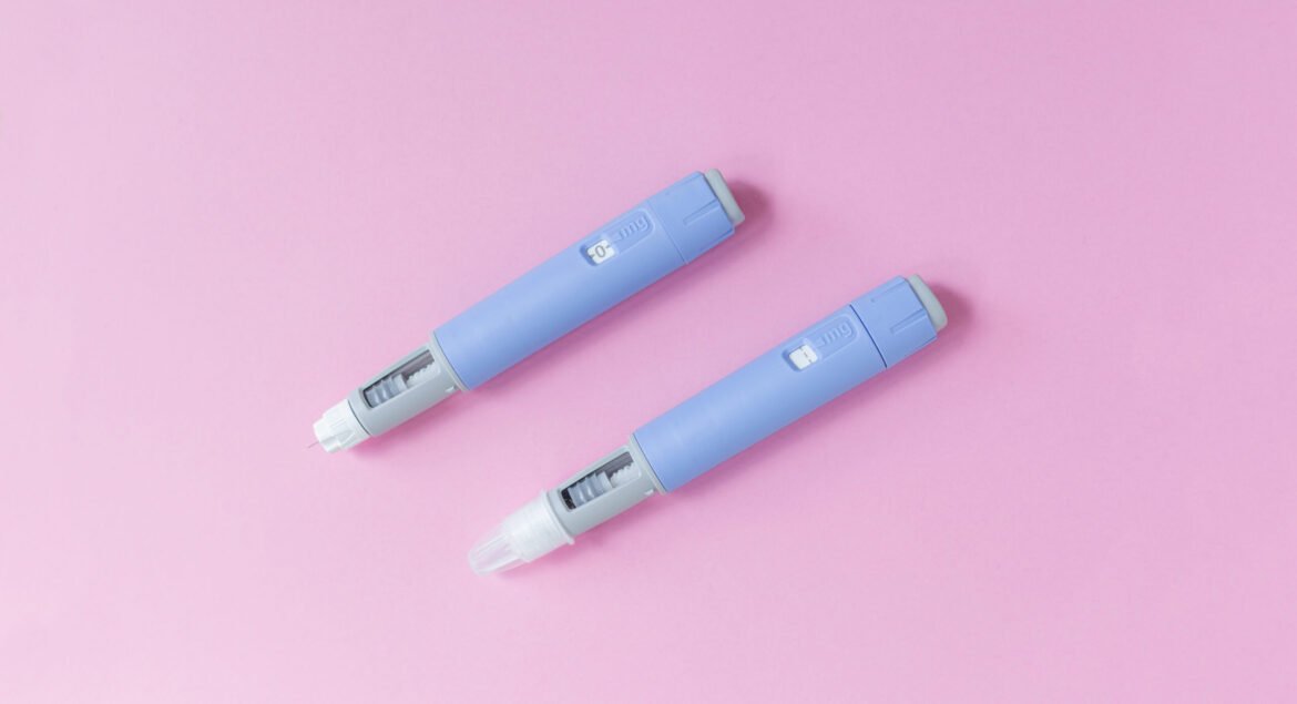 medical drug Ozempic injection lies on a pink background, top view. Medicine and weight loss, concept. injectors dosing pens for subcutaneous injection of antidiabetic medication or anti-obesity
