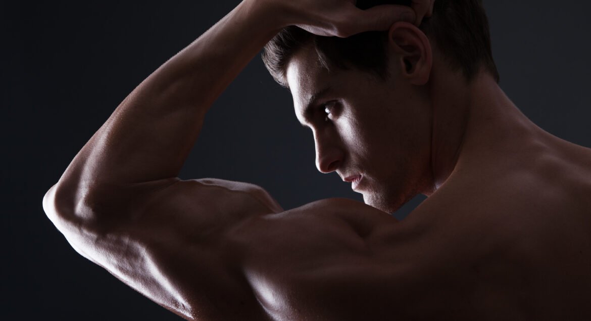 Stylized portrait of handsome muscular man flexing bicep
